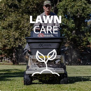 A man in a lawn mower providing lawn care services.