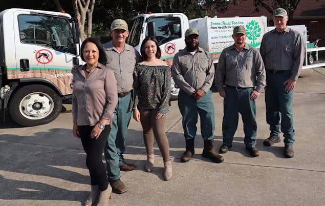 Six people stand in front of two work trucks displaying Pest Control Tarrant County, TX | Trees Hurt Too, Inc. signage. Five wear uniforms while one woman is dressed casually, all representing the company’s professional team. Six people stand in front of two work trucks displaying Pest Control Tarrant County, TX | Trees Hurt Too, Inc. signage. Five wear uniforms while one woman is dressed casually, all representing the company’s professional team.